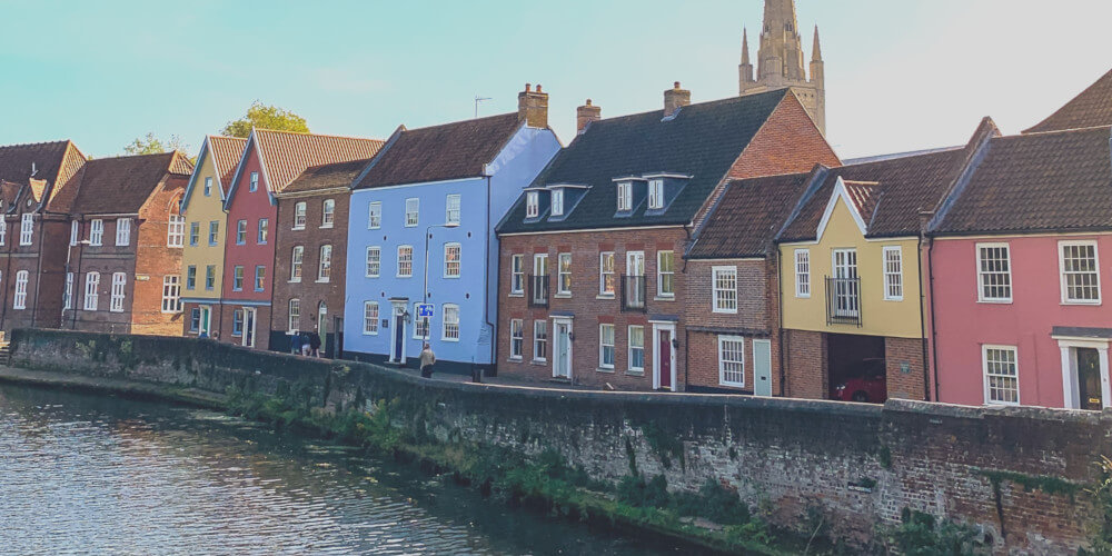 View of colourful houses along the riverside in Norwich where Norwich copywriter, Georgie Matthews is based. Near the Fye Bridge at the end of Magdalen Street and Tombland.